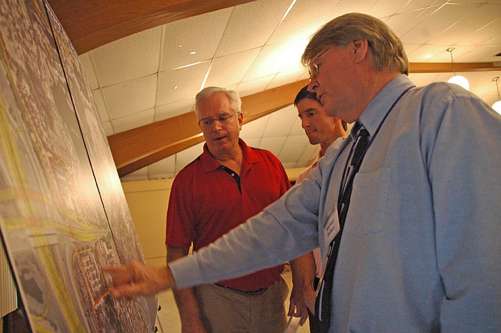 Photo by: Isaac Babcock - Michael Dollery of the Florida Department of Transportation (right) explains potential construction plans to visitors to an open house meeting Sept. 14 in Maitland.
