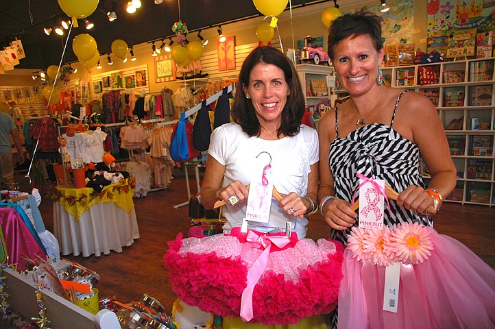 Photo by: Isaac Babcock - Tugboat & the bird owner Laura Haftel and manager Missy Riegel show off some of their wares at the store's 10th anniversary on Sept. 17.