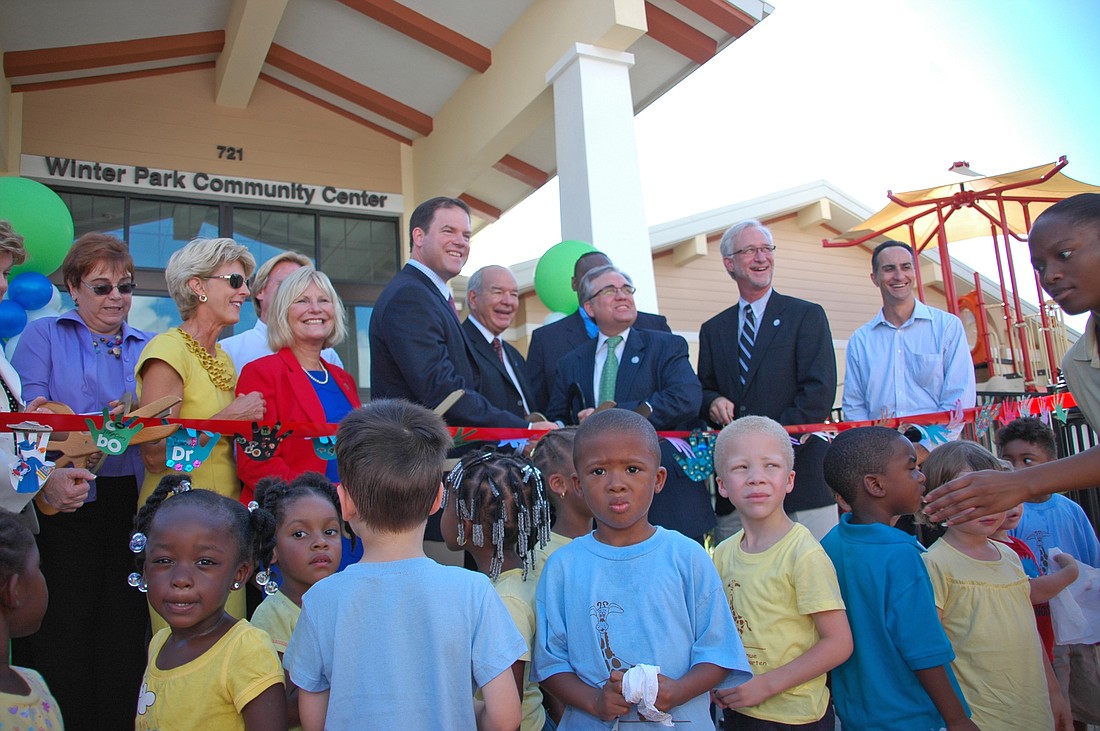 Photo by: Isaac Babcock - Commissioners, builders and city staff prepare to cut the ribbon for the Winter Park Community Center Sept. 23.