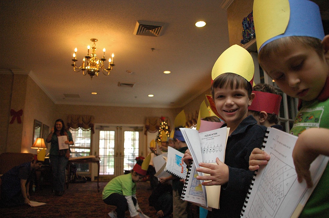 Photo by: Isaac Babcock - Kindergartners from the Jewish Academy of Orlando performed Hanukkah songs for residents at Savannah Court in Maitland on Thursday, Dec. 9.