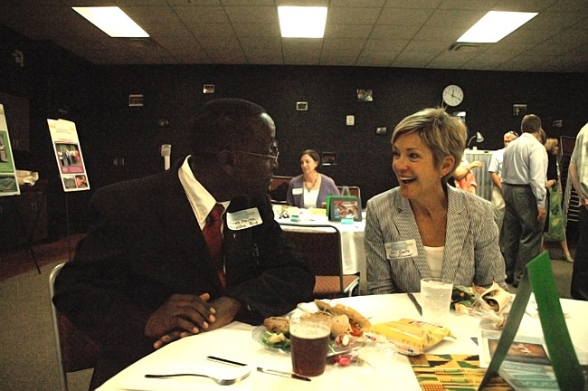 Photo by: Isaac Babcock - Rollins College Executive Director of the Center for Advanced Entrepreneurship Cari Coats talks with Kenyan Methodist Church Pastor Moses Maina at a reception for Panua organizers May 7.