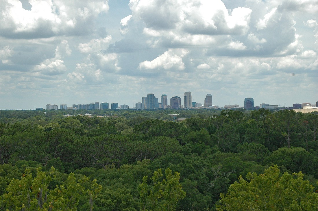 Photo by: Jeffrey Blydenburgh - The Orlando skyline spans the horizon, viewed from the Winter Park Fire Department's ladder truck at Mead Garden, top, showing the expanse of green to the west of the garden, and a new tree nursery.