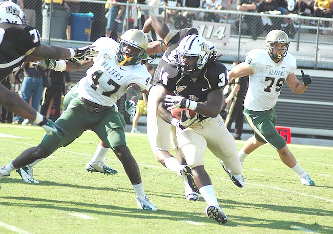 Photo by: Isaac Babcock - UCF running back Brynn Harvey races around UAB's defensive line during the Knights win Nov. 24.