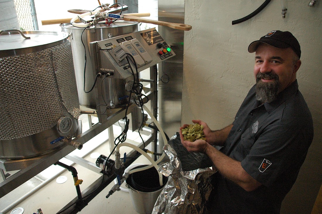 Photo by: Isaac Babcock - Ron Raike, a self-proclaimed 'beer geek', cradles hops used to brew custom beer at the Shipyard Emporium. He says the eatery will have beer to please anyone's tastes.