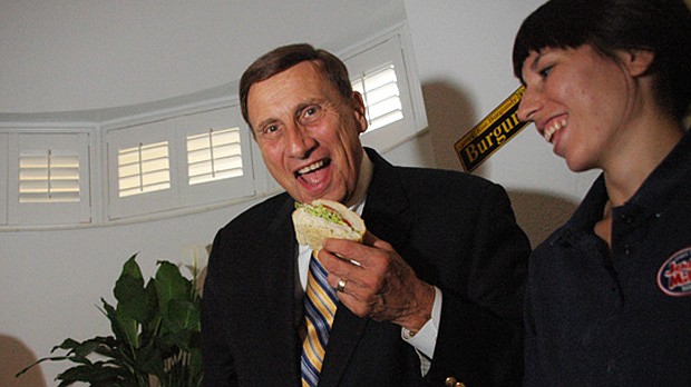 Photo by: Isaac Babcock - U.S. Rep. John Mica takes a bite at last year's Tastefully Goldenrod charity food fest.