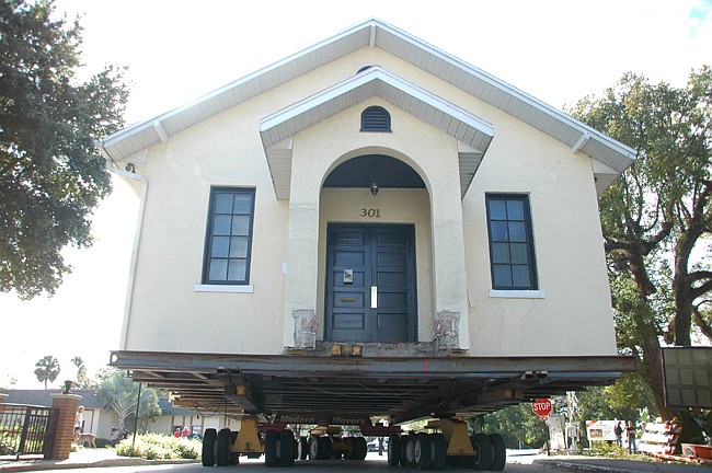 Photo by: Tim Freed - The Winter Park Wedding Chapel rolls to its new plot after being uprooted Sunday.