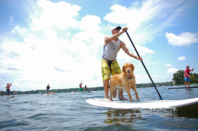 Photo by: Isaac Babcock - Dogs rode the waves at a Stand Up Paddling Day event June 10 in Winter Park, which benefited Pet Rescue by Judy.