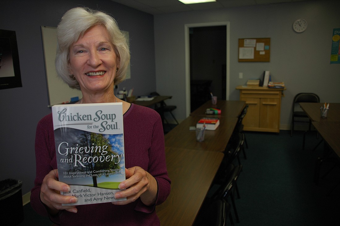 Photo by: Isaac Babcock - Bettie Wailes tutors college prep classes, but has turned writing into a source of fame. Above, she shows off  "Grieving and Recovery", in which her story "The Secret Shopper" appears. The author is also an avid runner, compe...