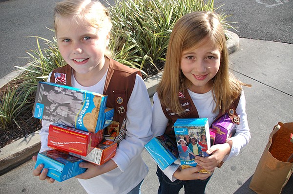Photo by: Isaac Babcock - Samantha Chick and Anne Yeilding of Brownie Troop 2091 pose with cookies in front of the Baldwin Park Publix.