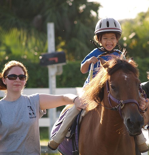 Photo courtesy of Freedom Ride - Disabled people connect with horses at Freedom Ride therapeutic horseback riding, which has volunteers and riders from across Central Florida.