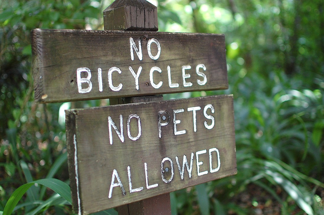 Photo by: Tina Russell - A sign in Mead Botanical Garden reminds citizens that dogs are not allowed in most areas of the city park.