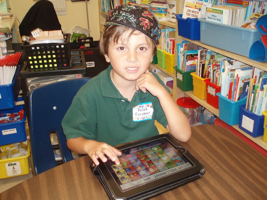 Photo courtesy of Jewish Academy of Orlando - Jewish Academy of Orlando student, Dylan Escobar, uses a new iPad on Monday.