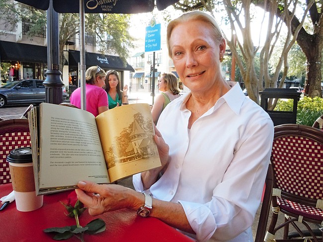 Photo by: Clyde Moore - Elaine Sullivan with her book "Winter Park Chain of Lakes: Boathouses Past & Present."