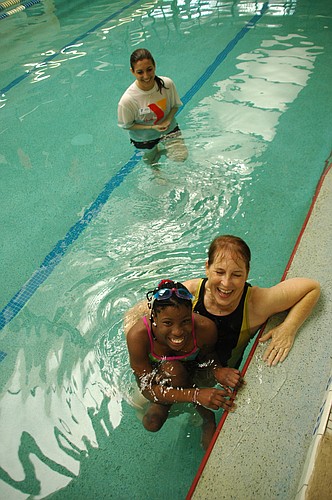 Photo by: Isaac Babcock - Twelve-year-old Elizabeth Dax swims at Crosby YMCA in Winter Park on Saturday morning with her 'foster grandmother' Cheryl Eller, who lives in Winter Park. Three days later, she was back in her country of Namibia, where her f...