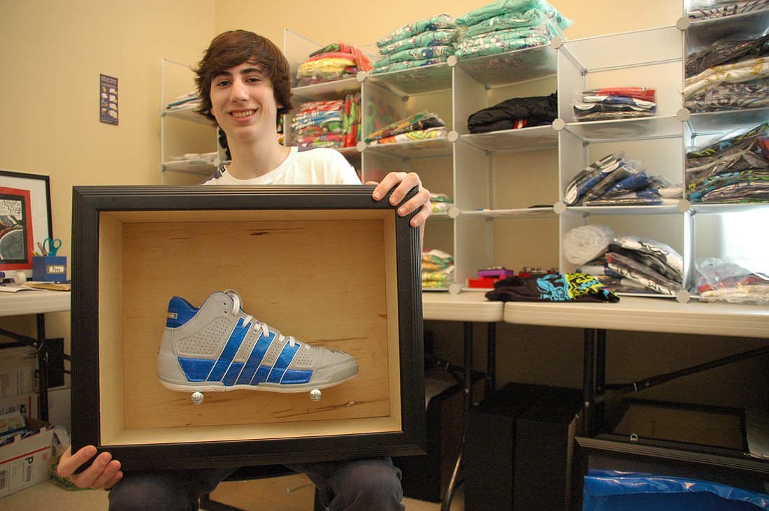 Photo by: Isaac Babcock - Corey Kamenoff, 16, shows off one of his custom sneaker cases at his home in Baldwin Park. Behind him are T-shirts and other items he sells through his Web site, SketchyWhiteVan.com.