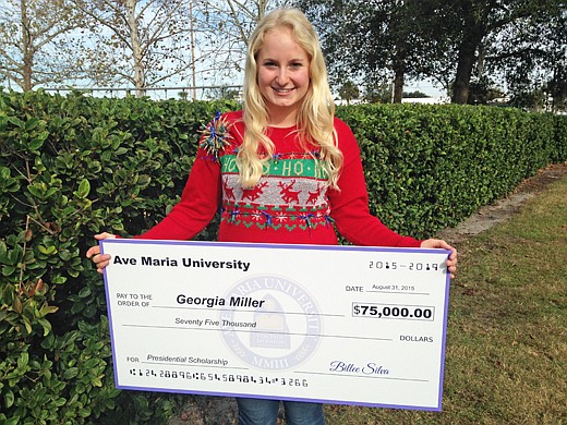 Photo by: Brittni Larson - Georgia Miller holds the scholarship check she received from Ave Maria University at The Geneva School.