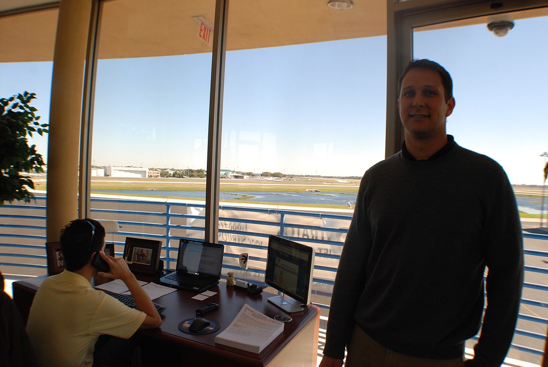 Photo by: Abraham Aboraya - Joel Thomas, president of Stratos, right, poses at their office at the Orlando Executive Airport. Their planes flew to Haiti.