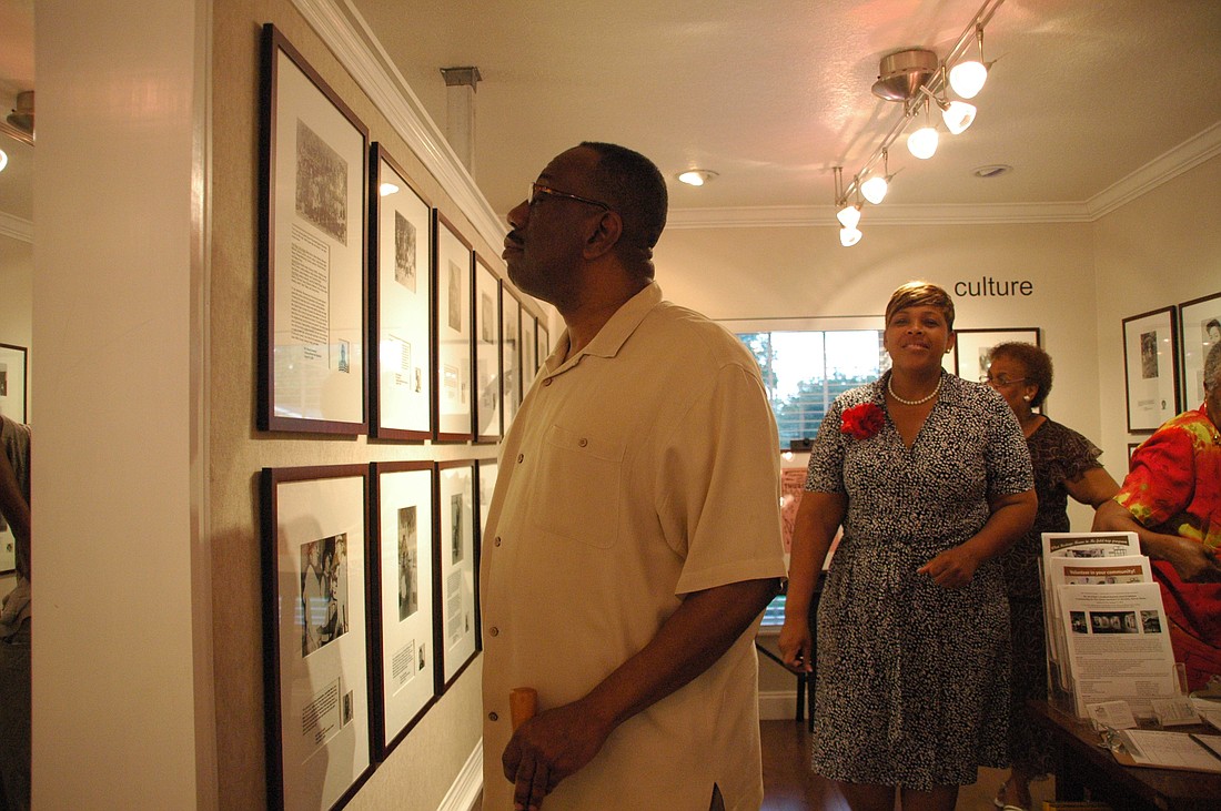 Photo by: Isaac Babcock - A visitor admires Hannibal Square Heritage Center's new exhibit, which tells the story of west side Winter Park and the everyday people who made a big difference in the city.