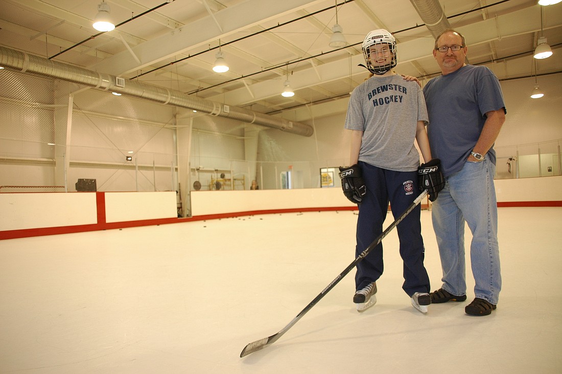 Photo by: Isaac Babcock - Grace Murphy and dad Steve Murphy pose on the rink at Orlando Hockey Training Center, the place where Grace practices when she's not on the road.