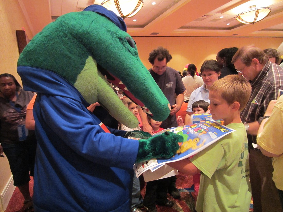 The University of Florida's mascot Albert signs and autograph for a fan as part of New Hope for Kids' meet and greet before the Celebrity Mascot Games July 19.