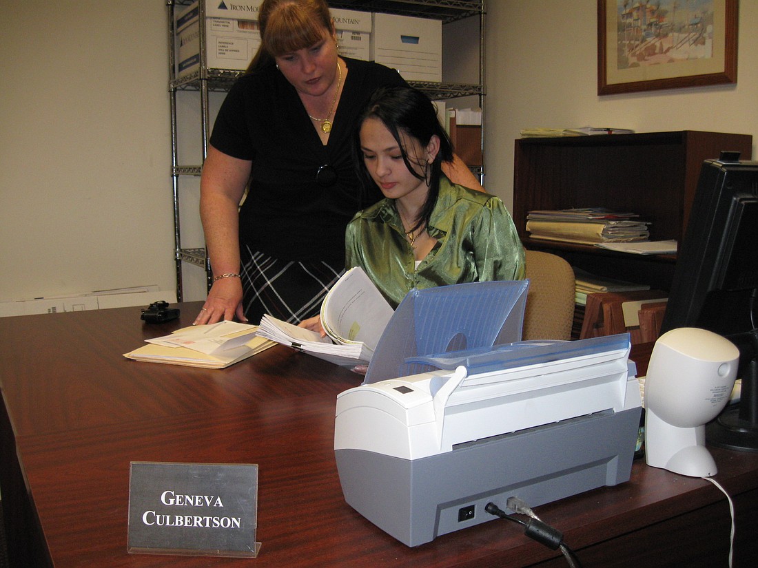 Photo by: Karen McEnany-Phillips - H.R. Director Kristin Shutler and Workforce Advantage Academy student Geneva Culbertson review case files at deBeaubien, Simmons, Mantzaris & Neal LLP law firm.