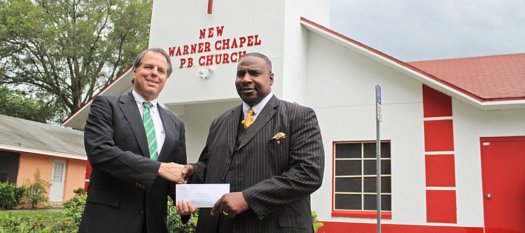 Photo by: Rebecca Males - Will Graves hands a check for $2,000 to Warner Chapel Primitive Baptist Church Pastor Mitchell Dawkins.