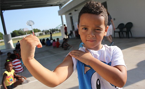 Photo by: Sarah Wilson - Aloma Elementary kindergartener Nichola Torres shows off his muscles. Orange County's programs have gotten more kids interested in healthy foods and fitness.