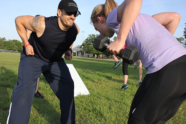 Photo by: Sarah Wilson - Instructor Paul Tardieu, left, works with Gladiator participant Jessie Anzevino, right.