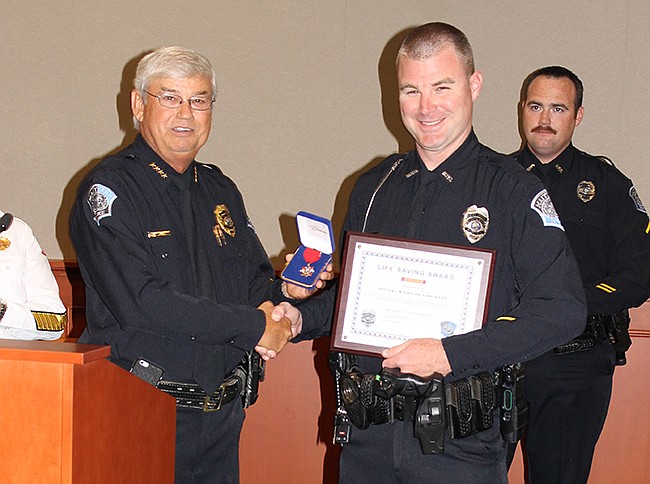 Photo: Courtesy of the city of Maitland - Police Chief Doug Ball honors officer Nickolas Lawrence.