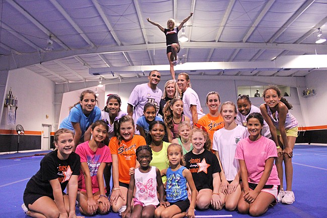 Photo by: Sarah Wilson - Winter Park cheerleading teams smile for the camera at their new gym.