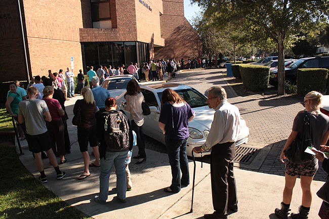 Photo by: Steven Barnhart - Orange County residents wait in line to vote at the Winter Park Library on Friday, Nov. 2. The next day, two suspicious packages postponed early voting for four hours.