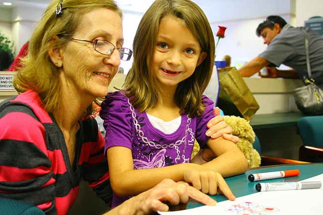 Photo by: Allison Olcsvay - Riley Crites, 7, with adopted "mom" grandmother Judy Crites at the National Adoption Day event held in Orlando Nov. 22. Dozens of families were officially created at the event.