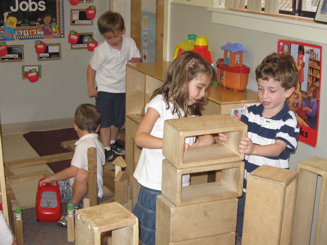 Photo by: Karen McEnany-Phillips - Sam Bermbaum and Kayla Gould, at right, play with big blocks at the JCC's Maitland campus recently. Several Maitland Jewish organizations lost funding this year.