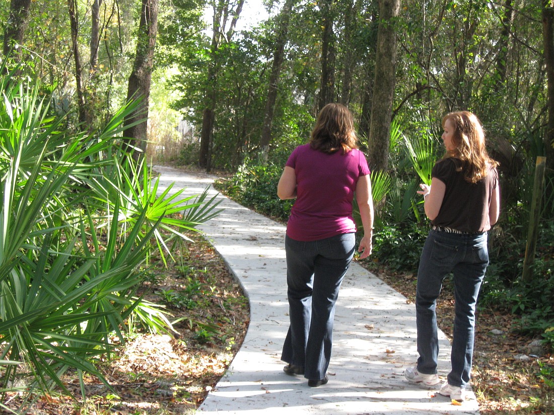 Photo by: Karen McEnany-Phillips - Life coach Julie Shepardson and client Lisa Rogers often meet on the walking trails outside of her office.