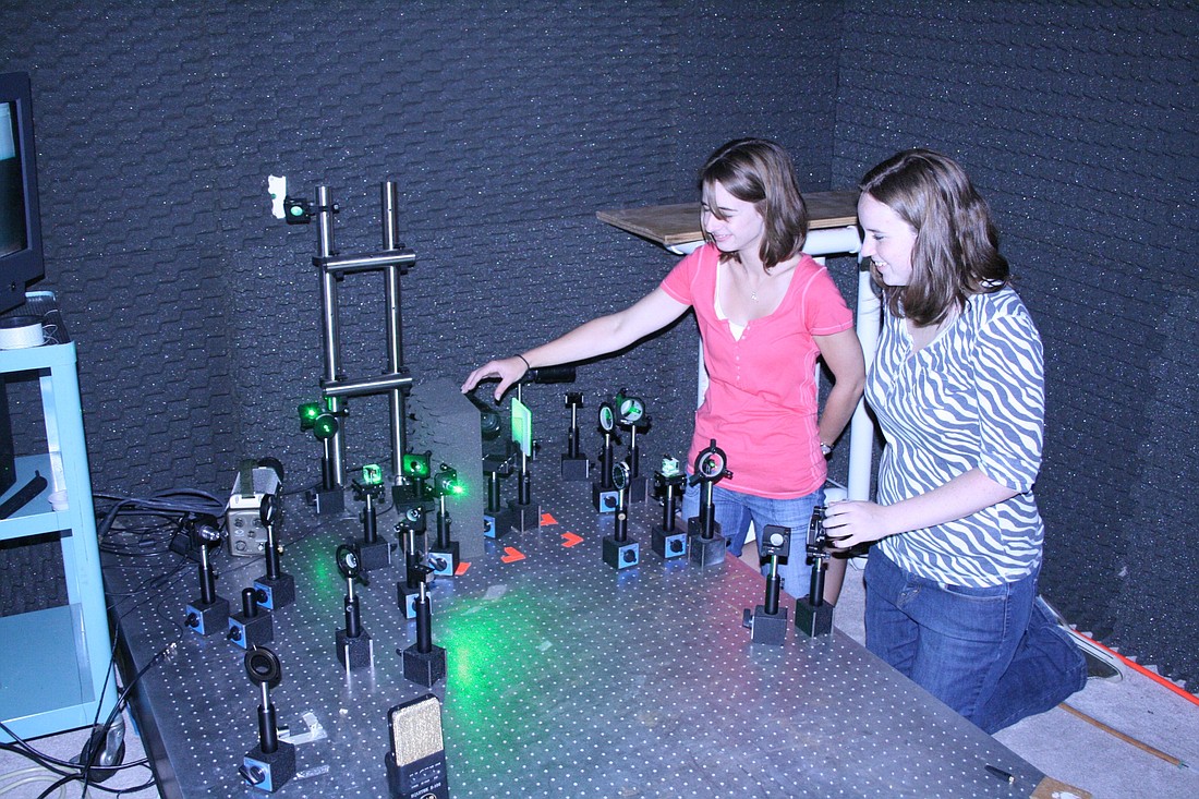 Photo courtesy of Seminole County Public Schools - Hagerty High School physics teacher Sarah Zietlow, left, and Rollins College student Ashley Cannaday, right, say they have a 100 percent success rate for detecting dangerous landmines using laser beams.
