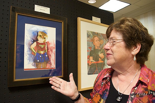 Photo by: Nada Hassanein - Artist Sharon Hunt shows some of her work. She started painting to balance life as a financial consultant. Forty years later, she's still doing it.