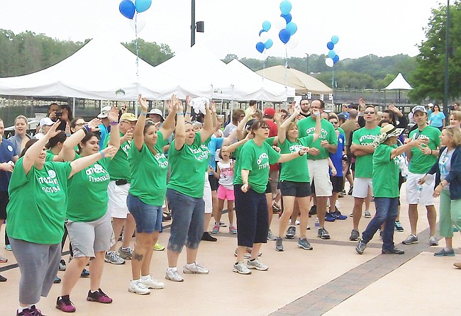 Photo: Courtesy of Moving Day Orlando - Moving Day participants get warmed up at last year's event, started to get the word out about studies showing that regular exercise can slow the degenerative disease's debilitating effects.