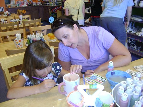 Photo by: Monique Valdes - A mother and a daughter work on a gift for dad on Sunday at Painted by Hue in Waterford Lakes. There are lots of ideas for Father's day gifts listed below.