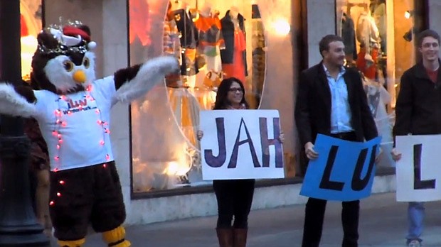 Photo by: Clyde Moore - Parker the Owl directs a chorus of carolers during a holiday flash mob on Dec. 23, orchestrated by I Luv Winter Park's Clyde Moore.
