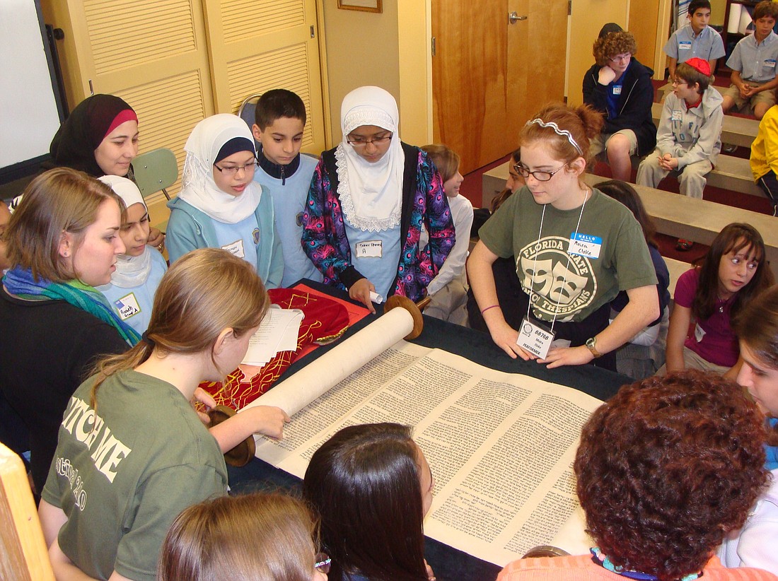 Photo by: Kristy Vickery - Jewish, Islamic and Christian middle school students learn about the Torah at a Multifaith Education Program at the Jewish Academy of Orlando in Maitland on Dec. 6. The groups will meet two more times at each other's schools.
