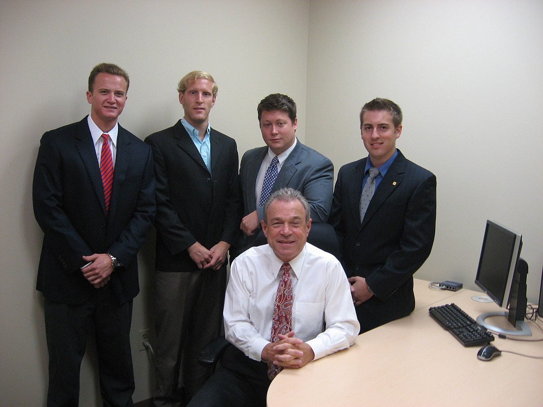 New associates Mitch Heidrich, Eric Parrs, Mike Heidrich Jr. and Aron Harrison pose with Paul Partyka, front.