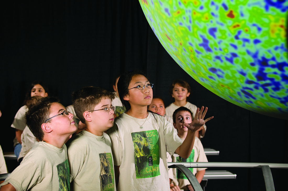 Photo by: Orlando Science Center - Children at a past Orlando Science Center spring break camp learn about "Science on a Sphere." Many camps are being offered.