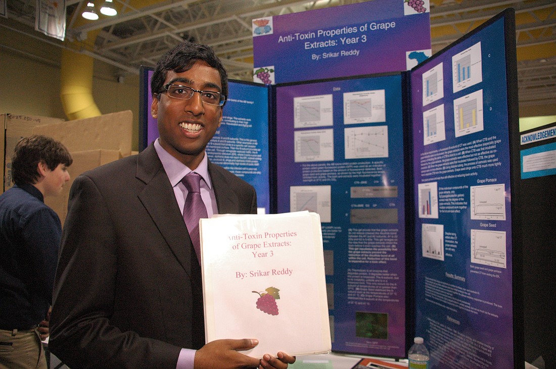 Photo by: Isaac Babcock - Srikar Reddy, 17, shows off his study of the anti-toxin properties of grape extracts, a science project he's been conducting for three years. Rollins College hosted the Orange County Science Fair on Feb. 14, giving budding sc...
