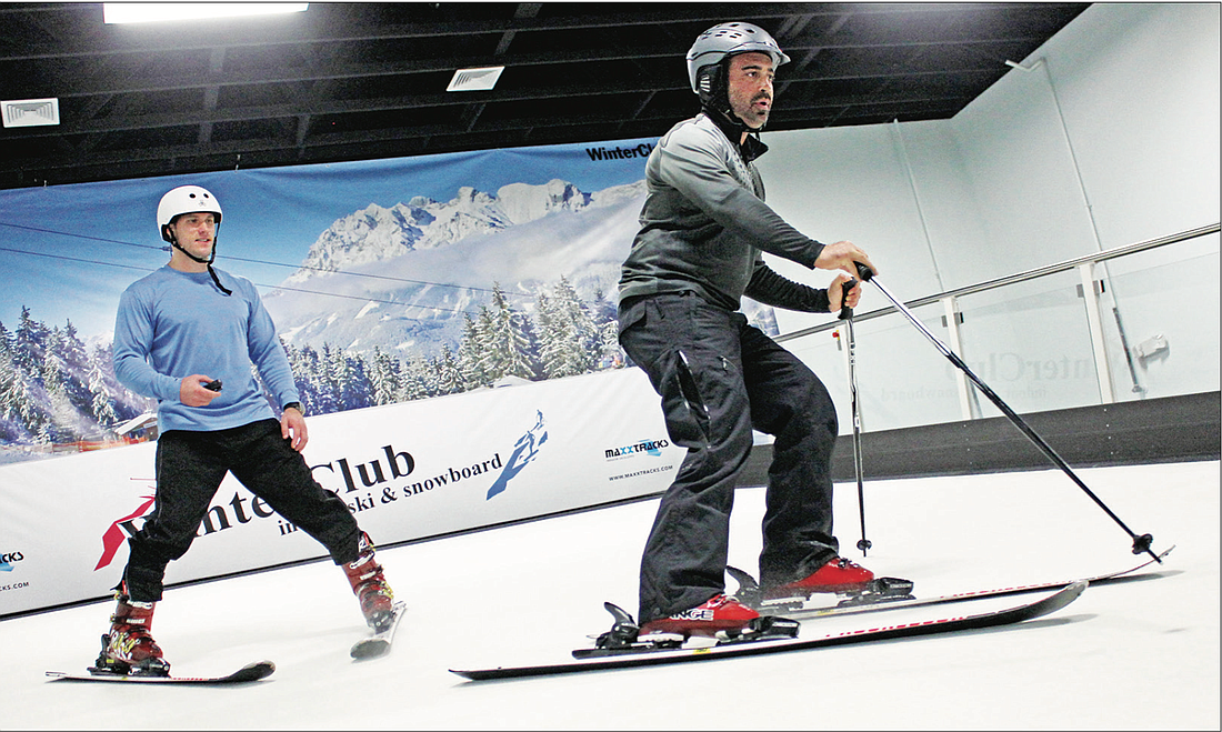Photo by: Sarah Wilson - WinterClub instructor Benjamin Wicks teaches Daniel Koren the ropes on the slopes during a lesson at the new indoor ski facility.