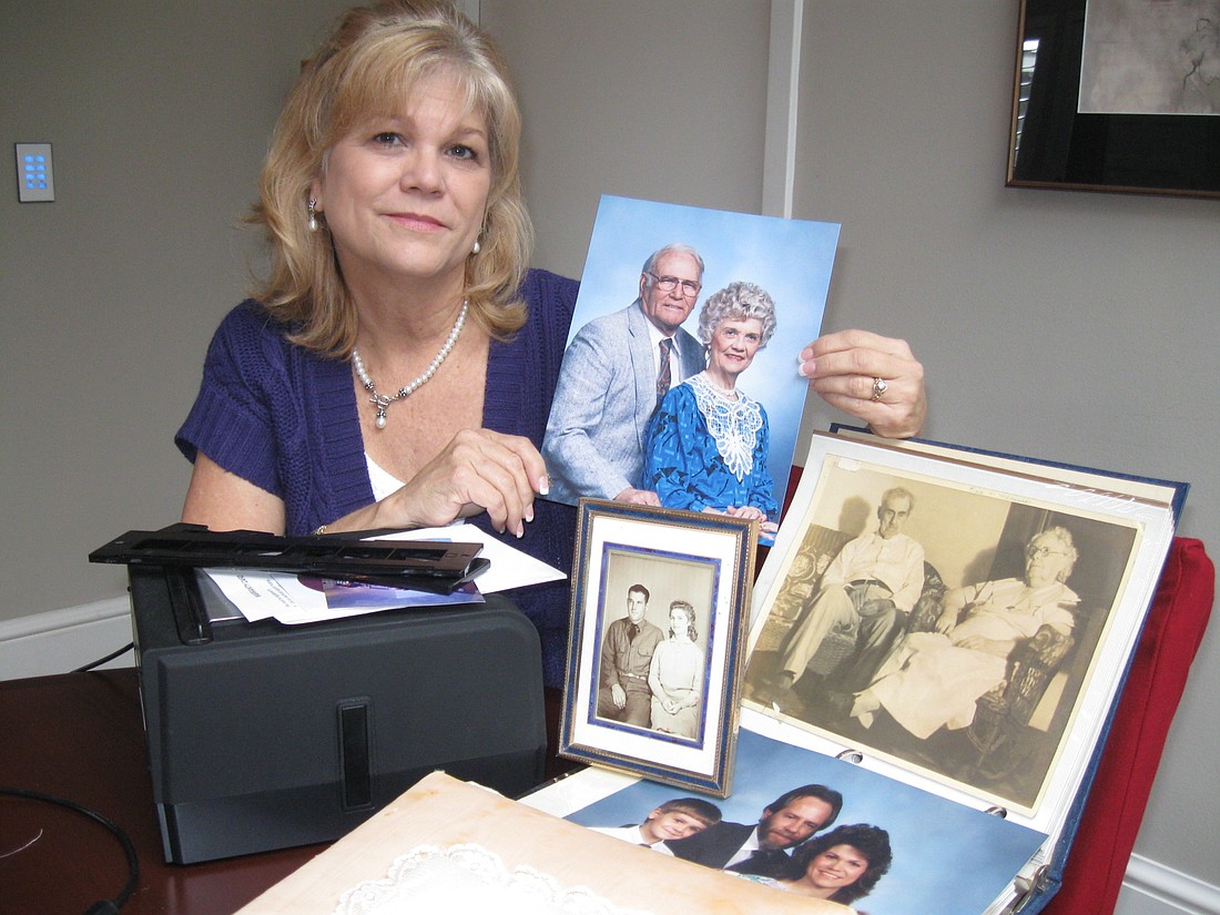 Photo by: Karen McEnany-Phillips - Terri Matern shows off three generations of her family. She tried to scan some of her photos herself but it was too cumbersome.