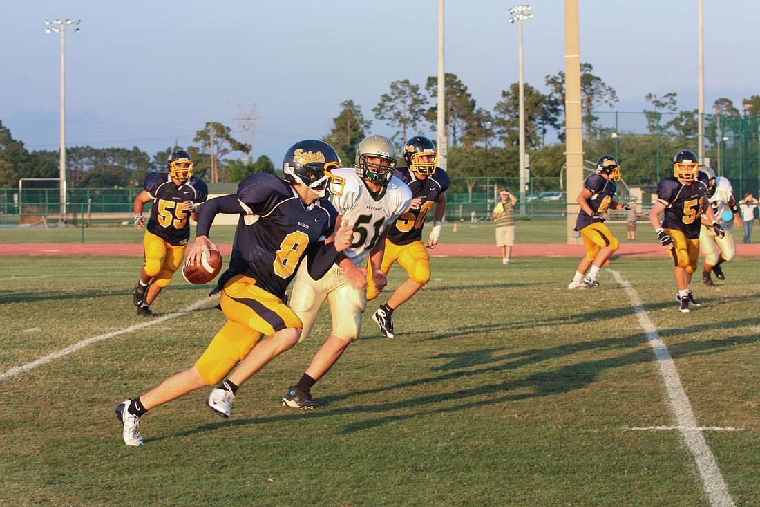 Photo by: Tina Russell - Trinity Prep failed to mobilize its offense against a tenacious The Villages team, falling by a 31-7 blowout in their spring game Friday. Winter Park also lost the same day.