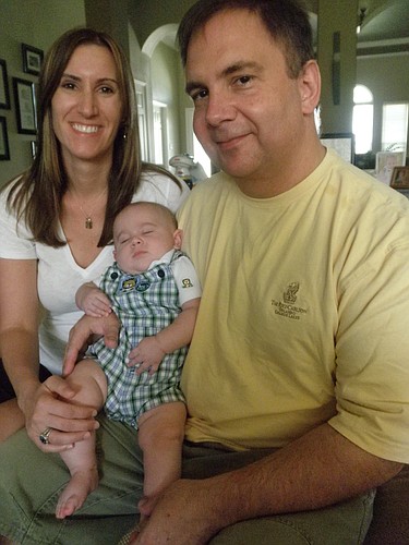 Photo by: Brittni Larson - Niki and Fred Trusty with son, Harrison, relax at their Ocoee home on July 31. Harrison was born on March 16, after a successful in vitro fertilization treatment they won at a Fertile Dreams conference last year.