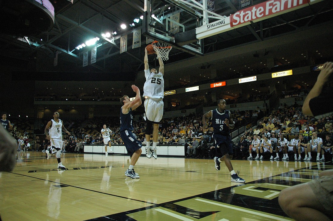 Photo by: Isaac Babcock - UCF forward A.J. Tyler goes airborne for a dunk during the Knights' rout of Rice on Saturday night, their first conference game.