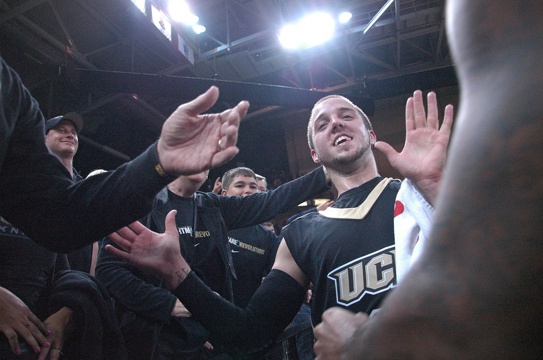 Photo by: Isaac Babcock - A.J. Rompza is mobbed by fans after the Knights beat USF Nov. 18, thwarting numerous Bulls' comeback attempts. Rompza led the team with 15 points, 5 rebounds.