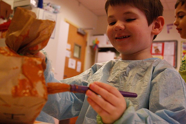 Photo by: By Katie Dees - Hayden, 4, paints his paper bag pumpkin a bright orange for the seasonal craft of the day in his classroom at the downtown UCP of Central Florida.